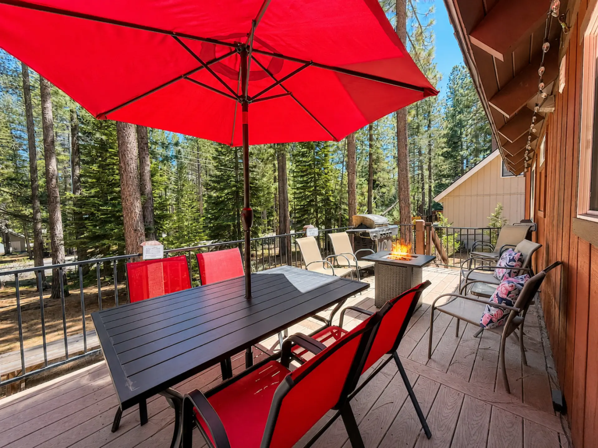 Back deck with gas fire pit, table & string lights