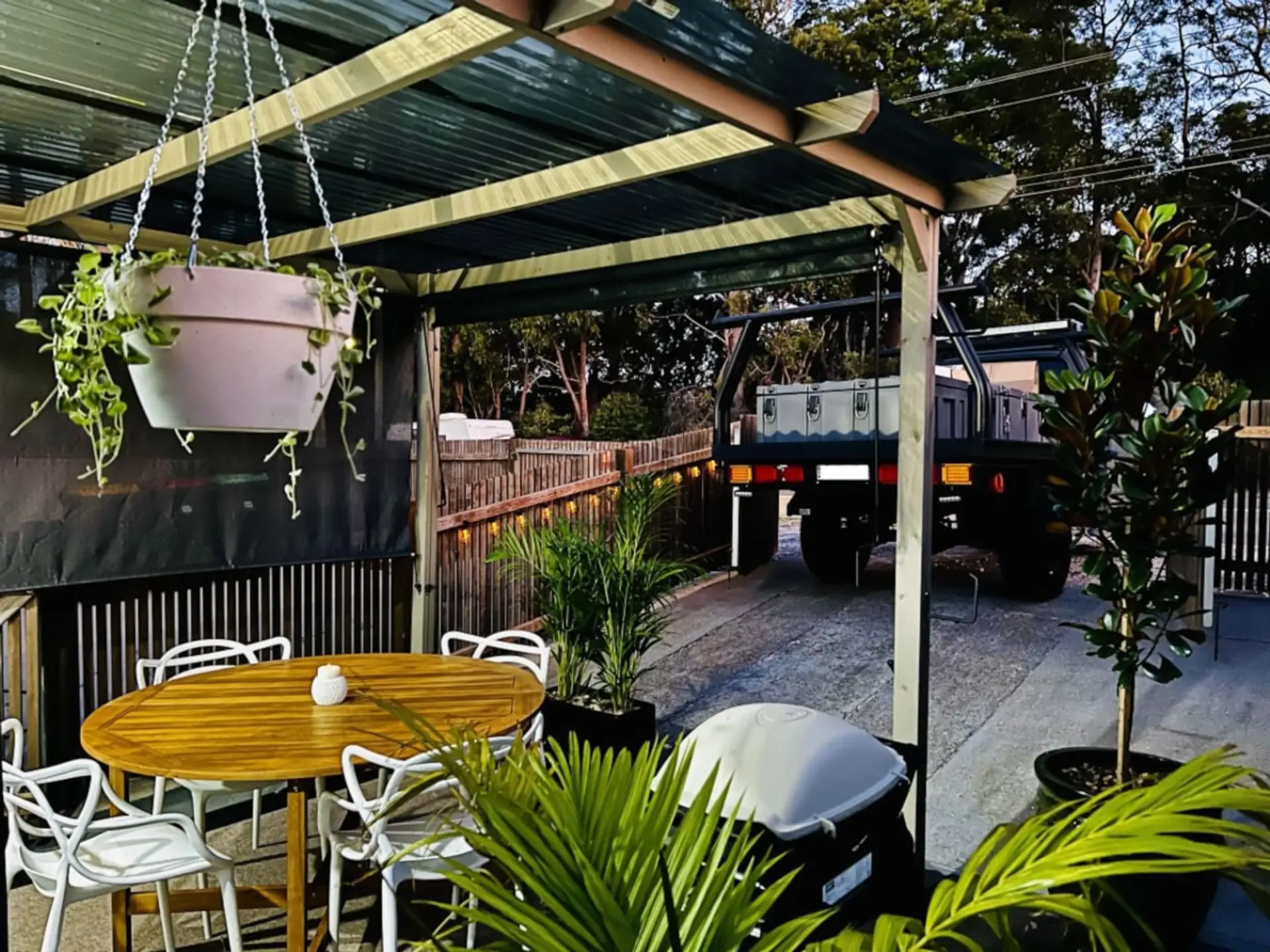 Sheltered pergola with BBQ & small car parking