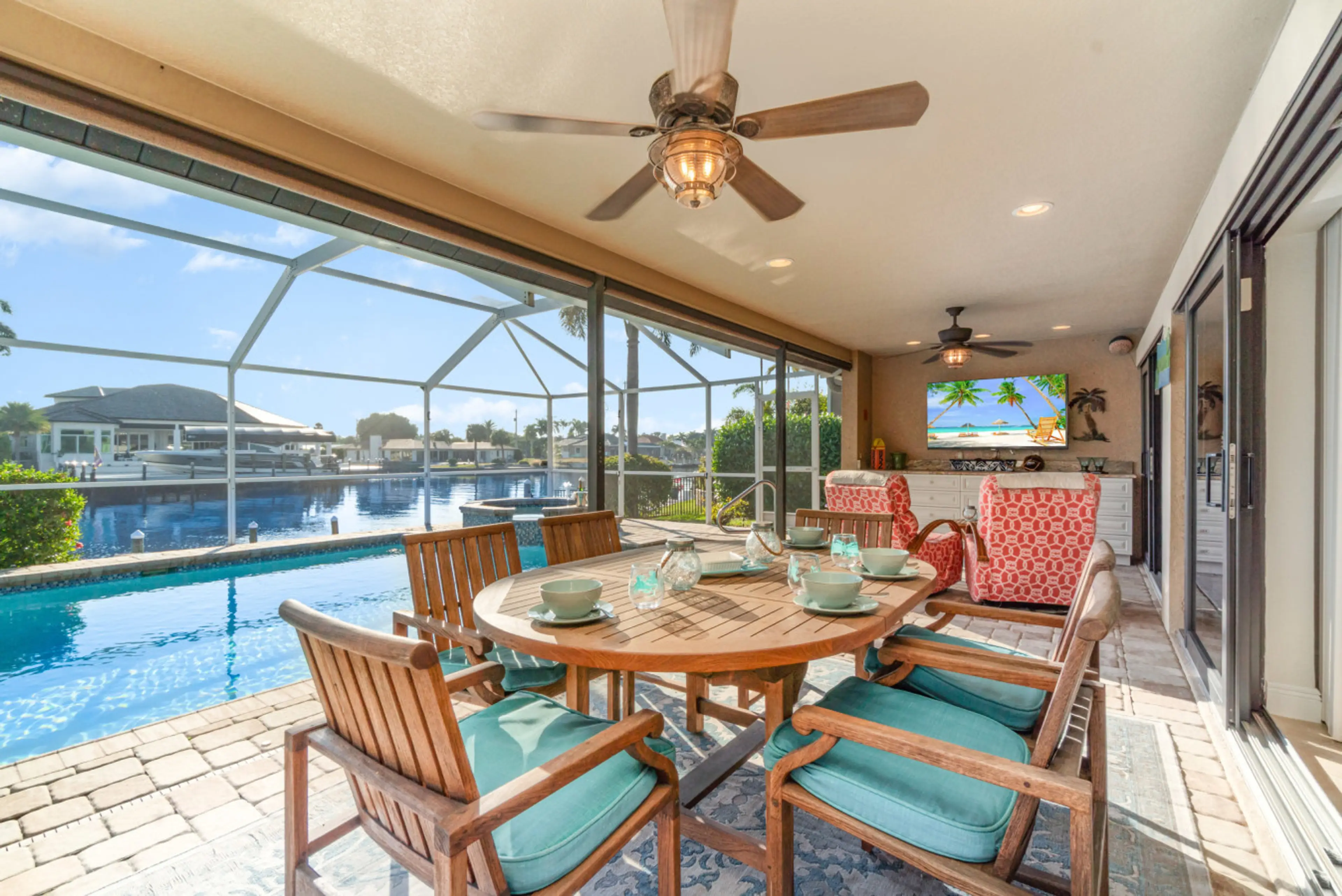 Resort-style outdoor living with dining area, lounge seating, and TV — perfect for day-to-night enjoyment.