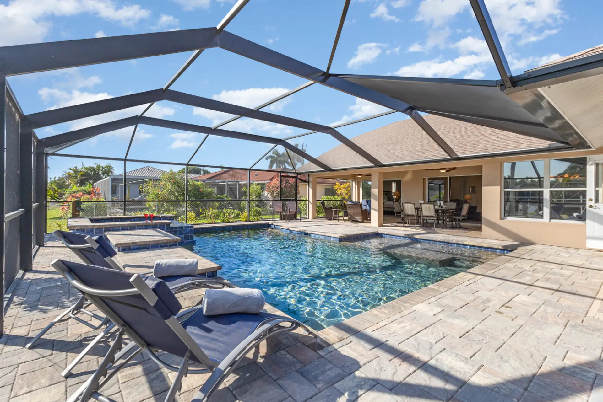 Your private resort oasis — heated pool, spa, sun loungers, and shaded lanai dining all in one stunning waterfront setting.