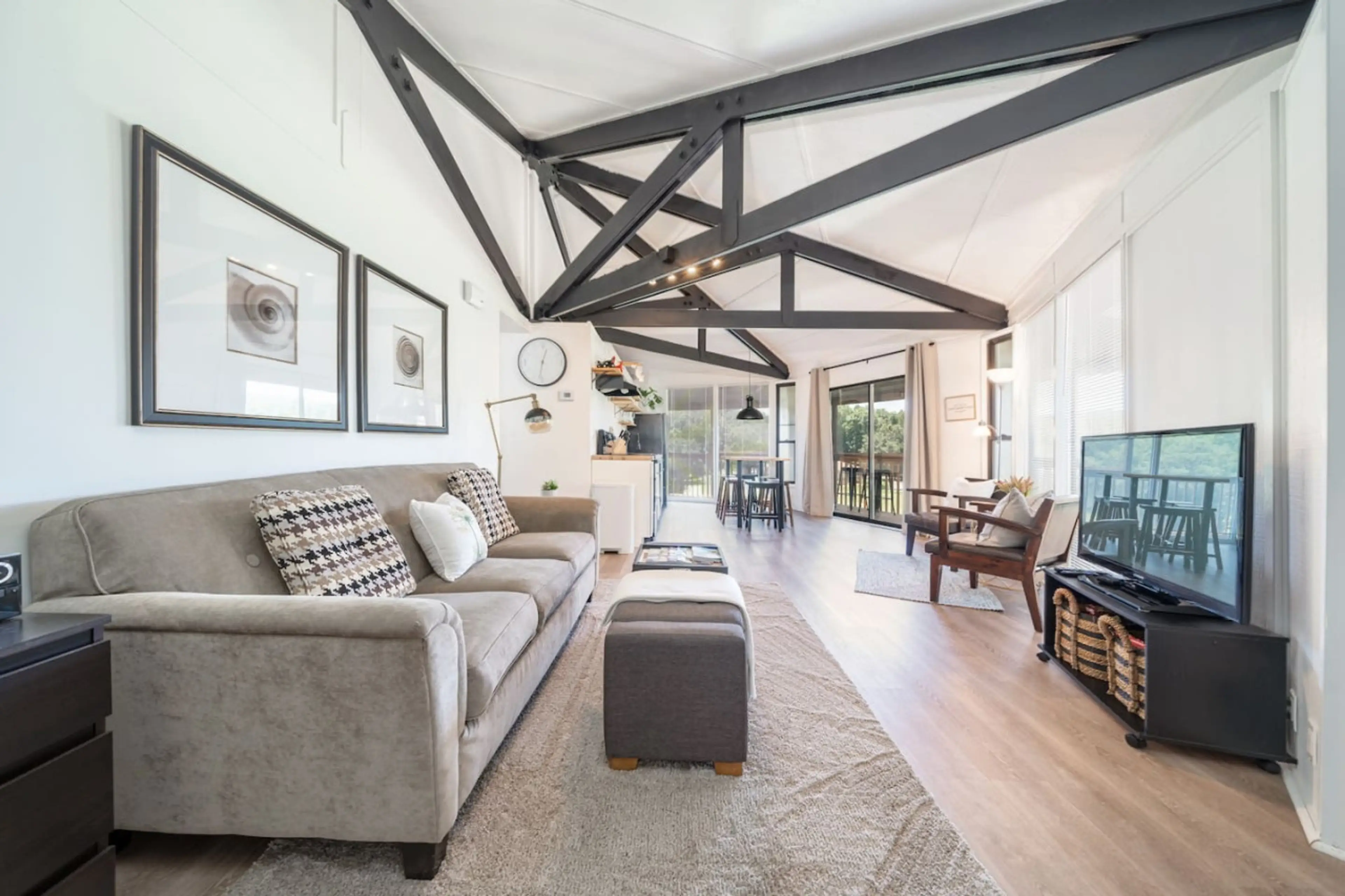Stylish living room with vaulted ceilings, exposed beams, and plenty of natural light.