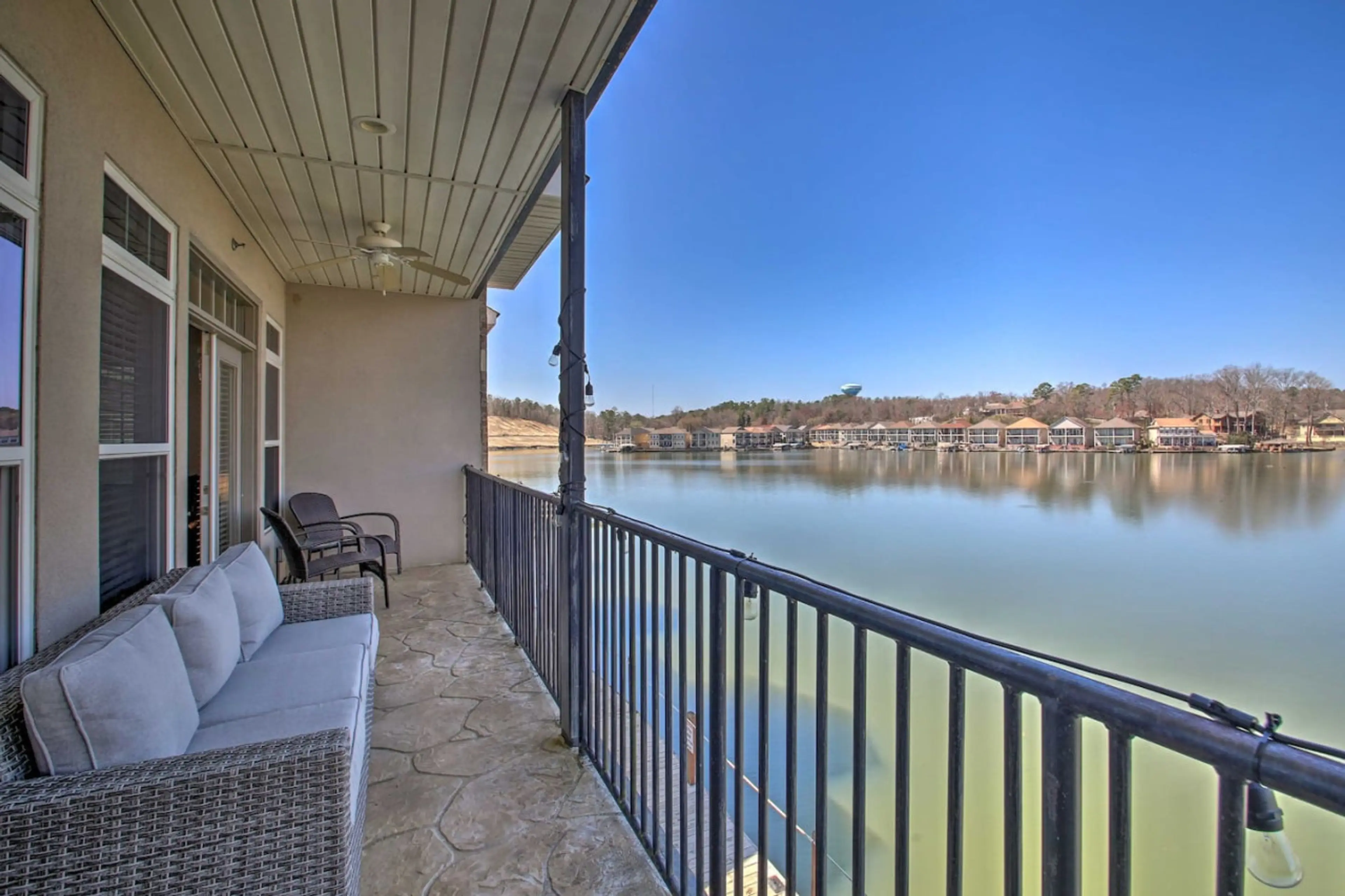 Private balcony overlooking the lake, complete with cozy seating to enjoy the view.