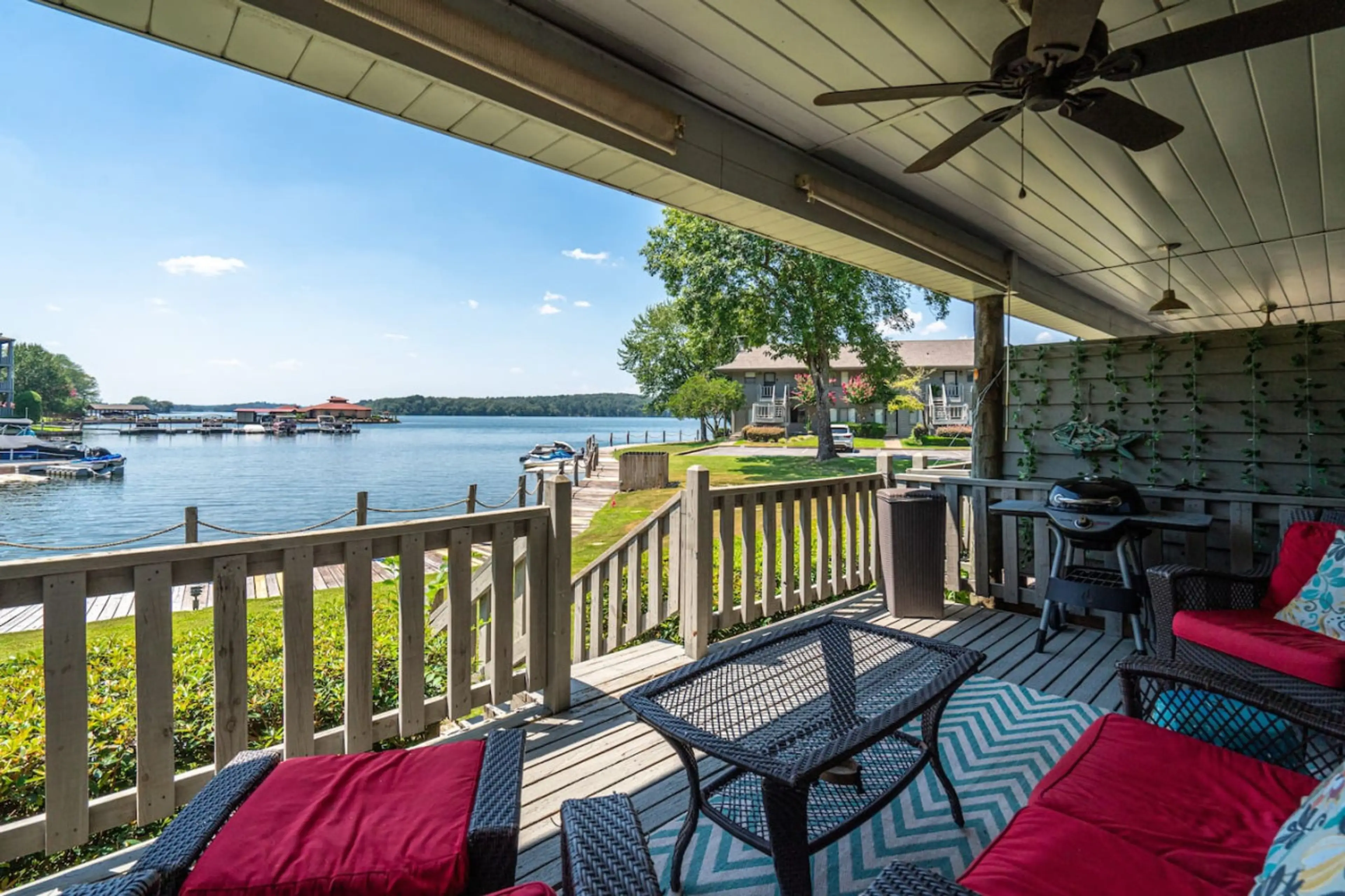 Relax on the covered patio with comfortable seating, ceiling fan, and stunning lake views.