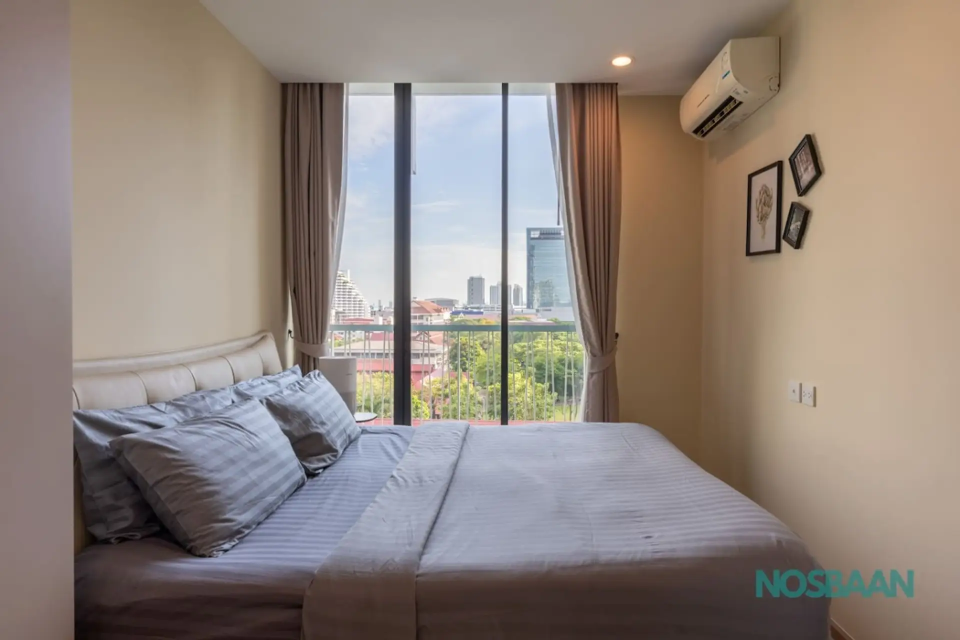 King-sized bed with city views and air purifier provided