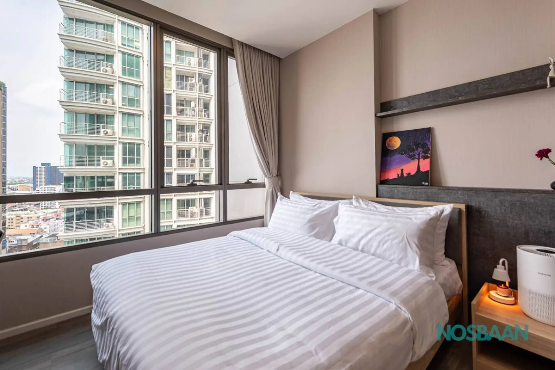 Queen-sized bed with city views and air purifier provided