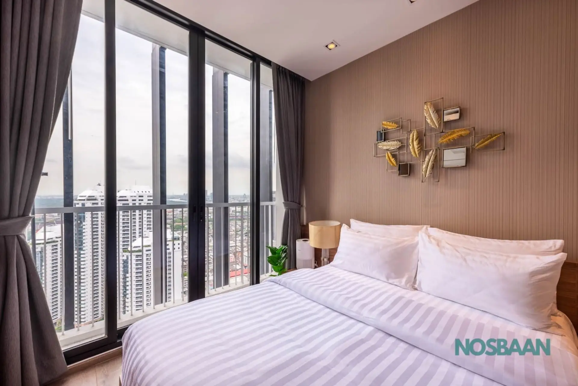Queen-sized bed with city sky views from the 40th floor and air purifier provided