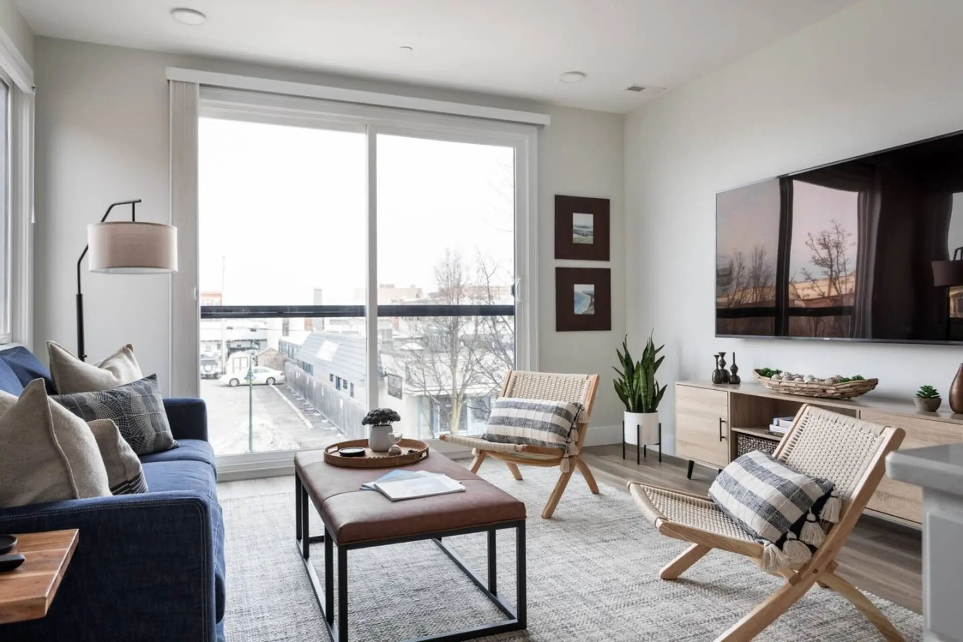 A view of the living room, tv, and a view of downtown Traverse City