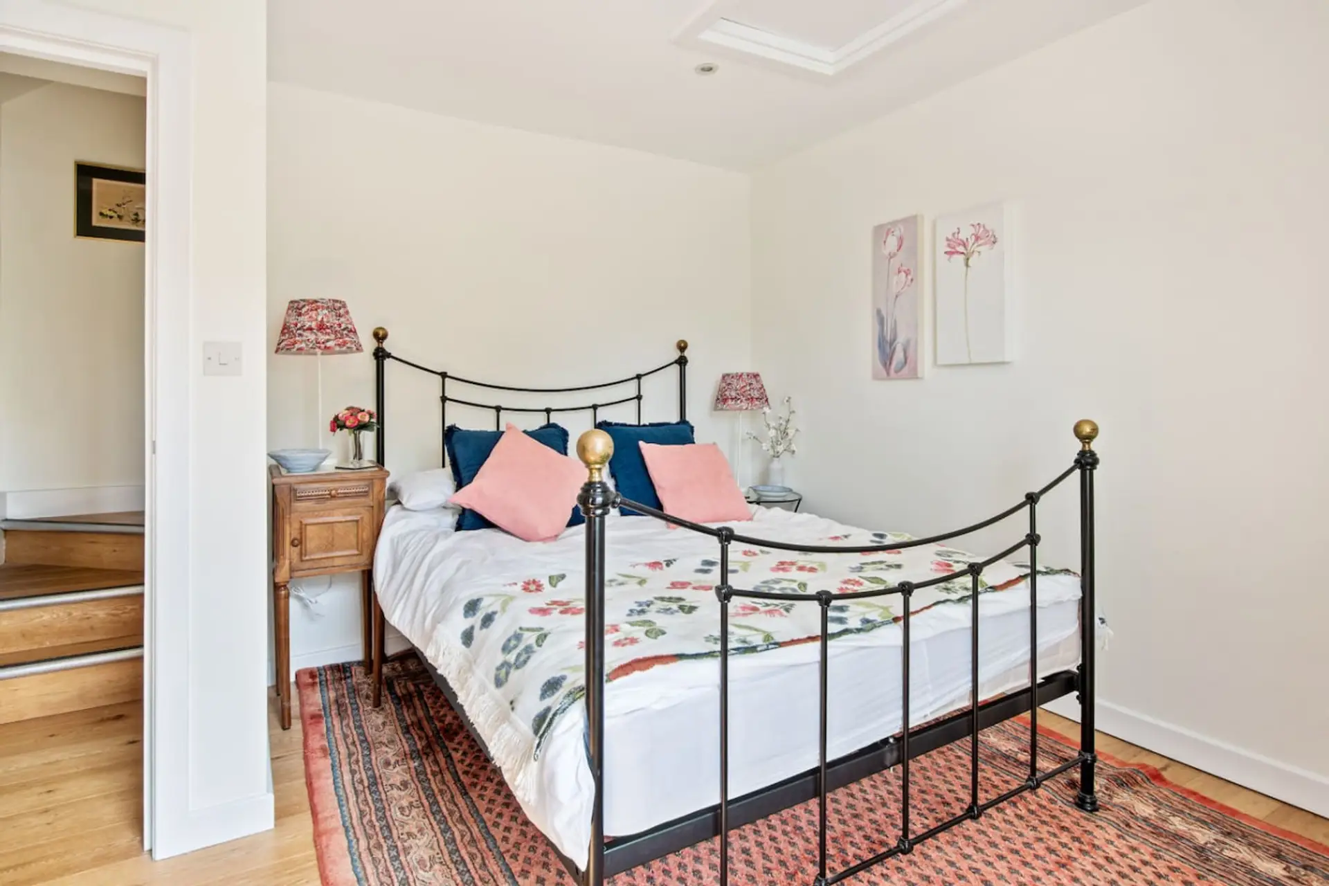 Double bedroom with floral touches and bright windows
