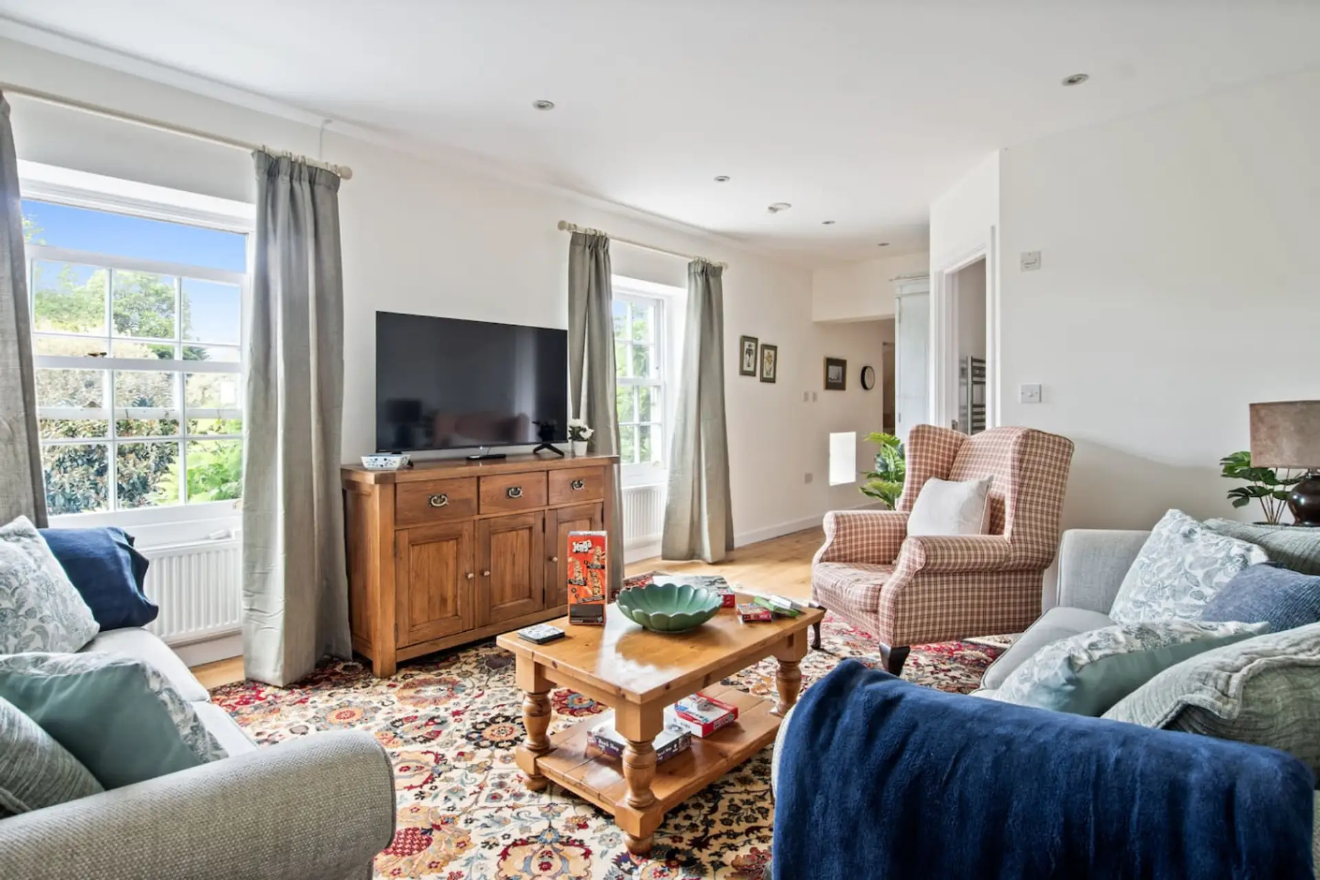 Light-filled lounge with comfy seating and Smart TV