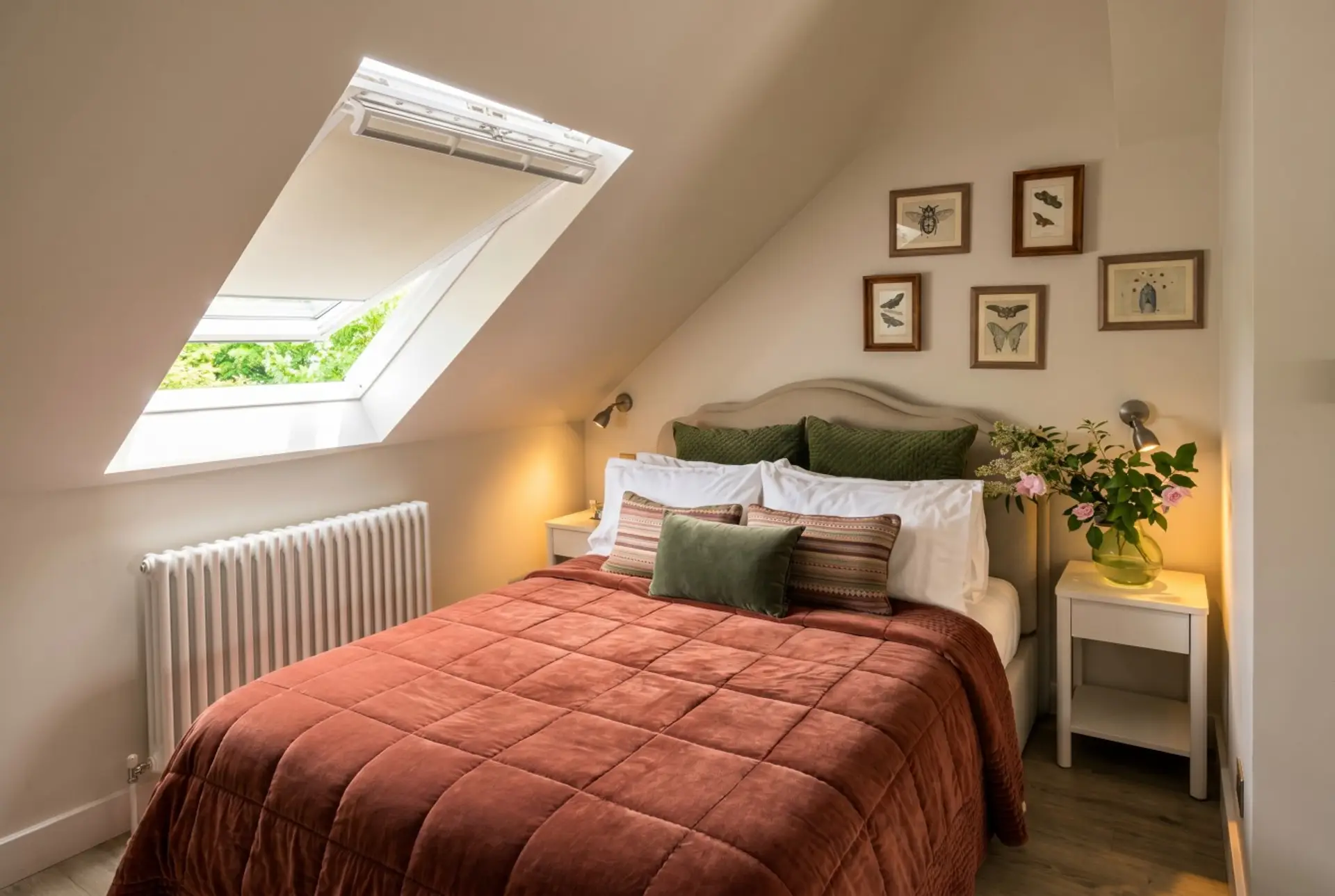 Skylit double bedroom with rich textiles and a leafy outlook.