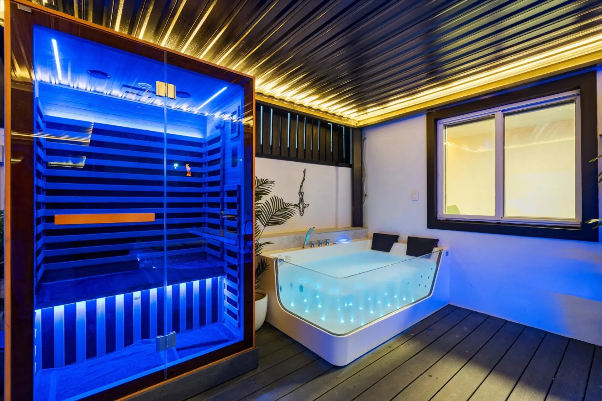 Private sauna and hot tub create a relaxing wellness retreat under the covered patio.