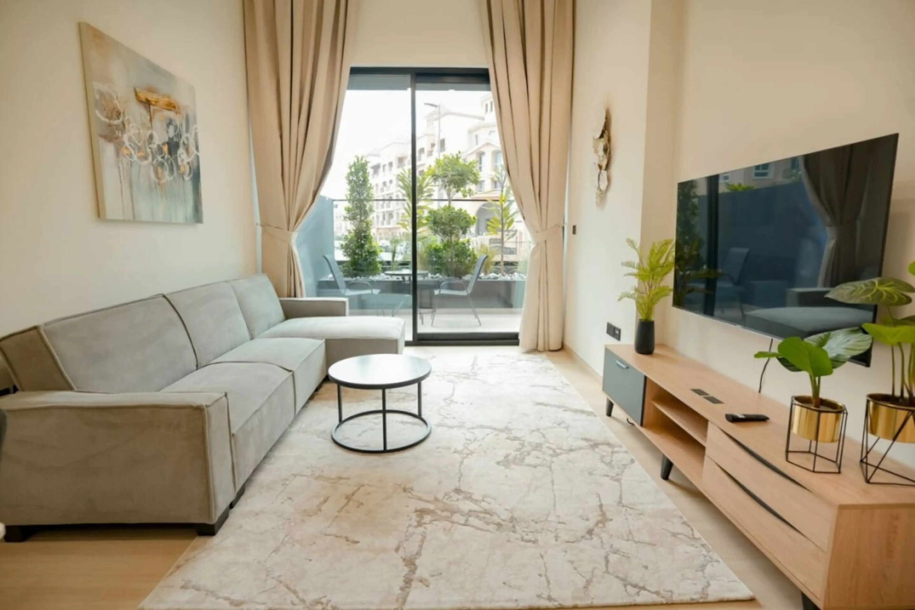 Bright living room with a cozy sofa, balcony access, and elegant modern decor.