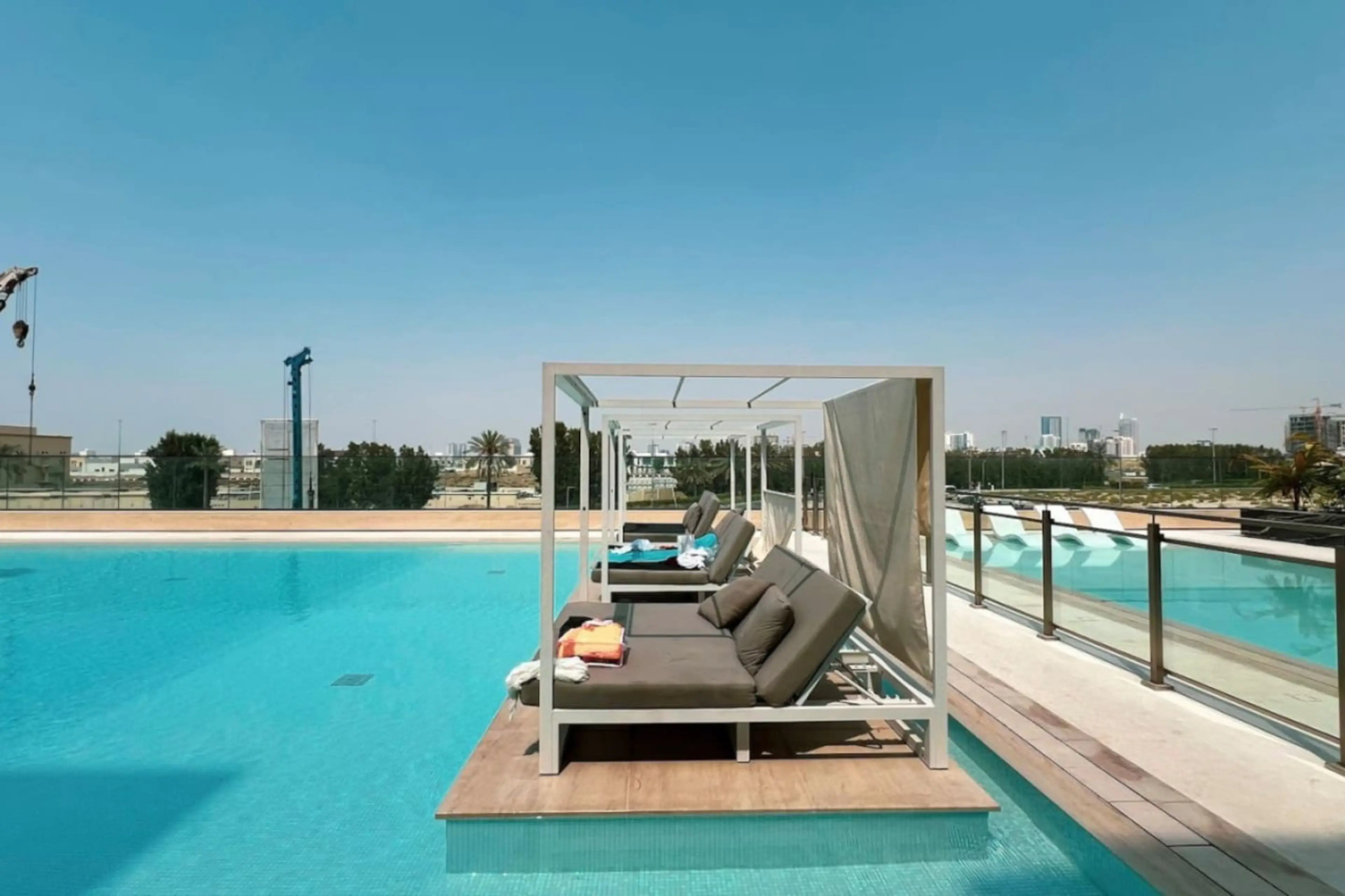 Luxurious poolside cabanas with stunning city views, perfect for relaxation.
