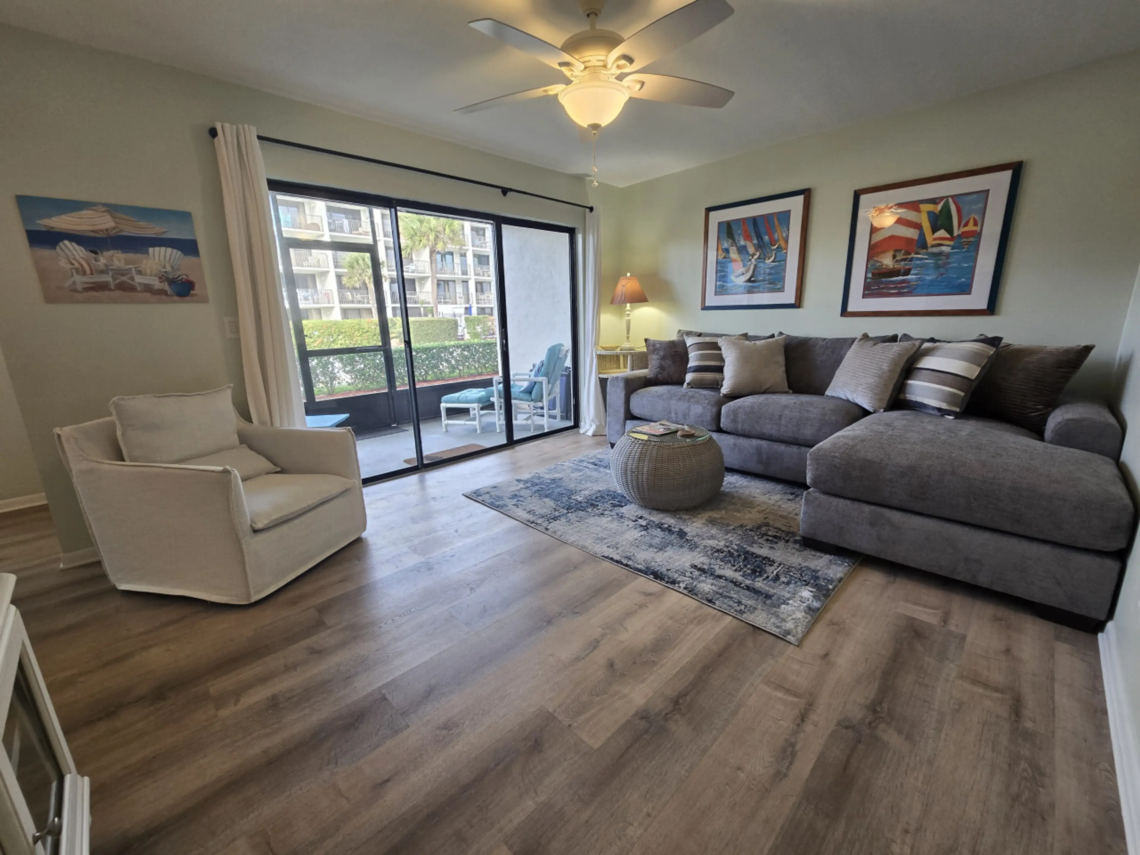 Bright living room with direct patio access — relax just steps from the beach