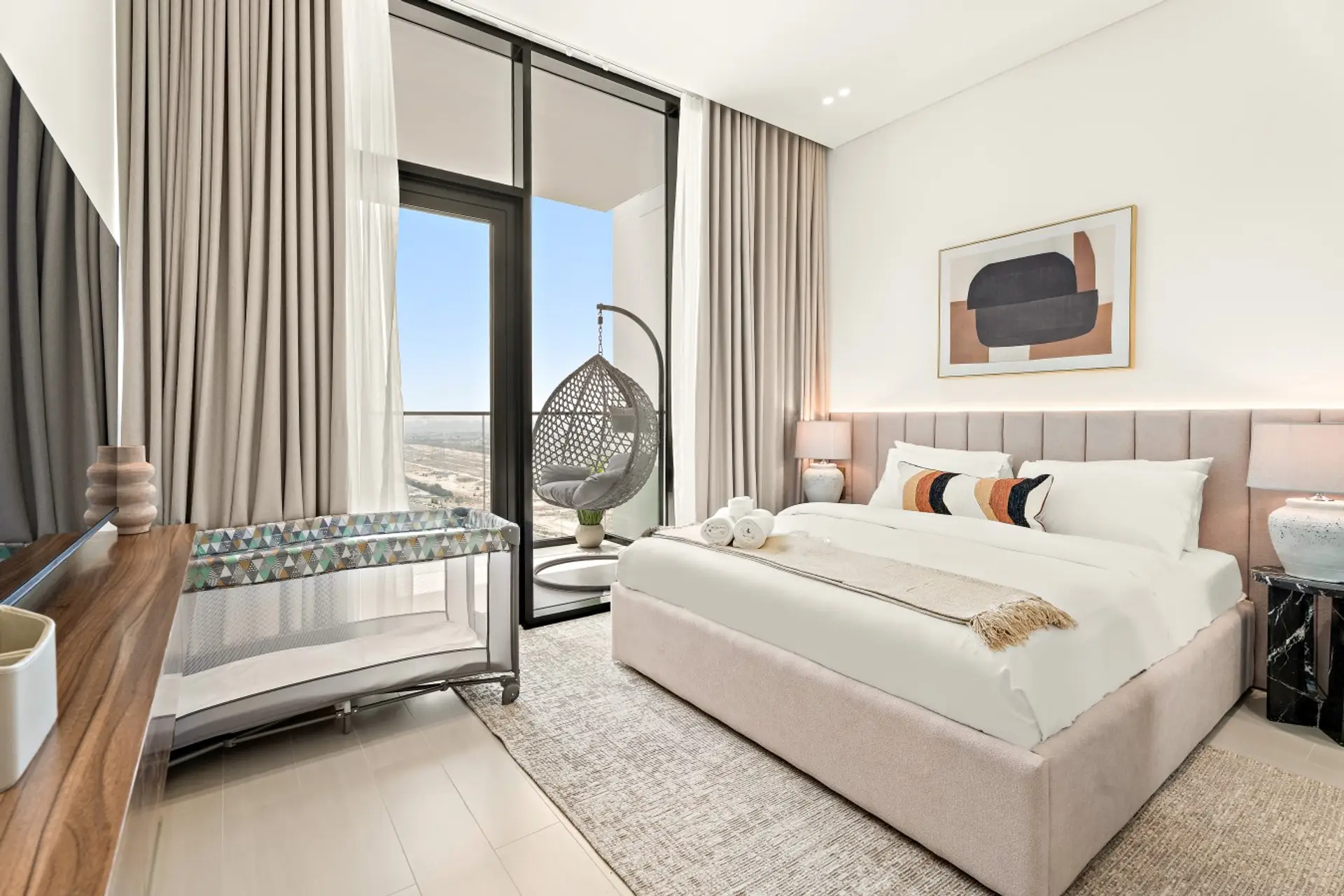 Bedroom: Relax in our serene bedroom, featuring a king-size bed with plush linens, a vanity table for your convenience, and a baby crib for your little ones.