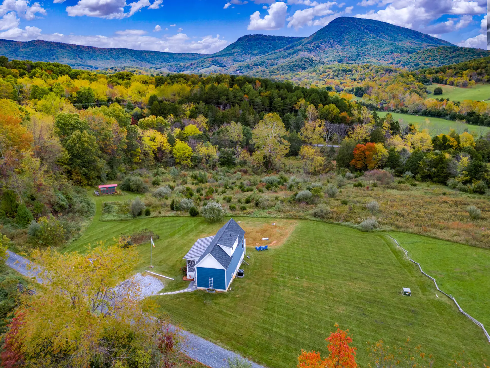 Bird’s-eye view of the property nestled in scenic natural surroundings.