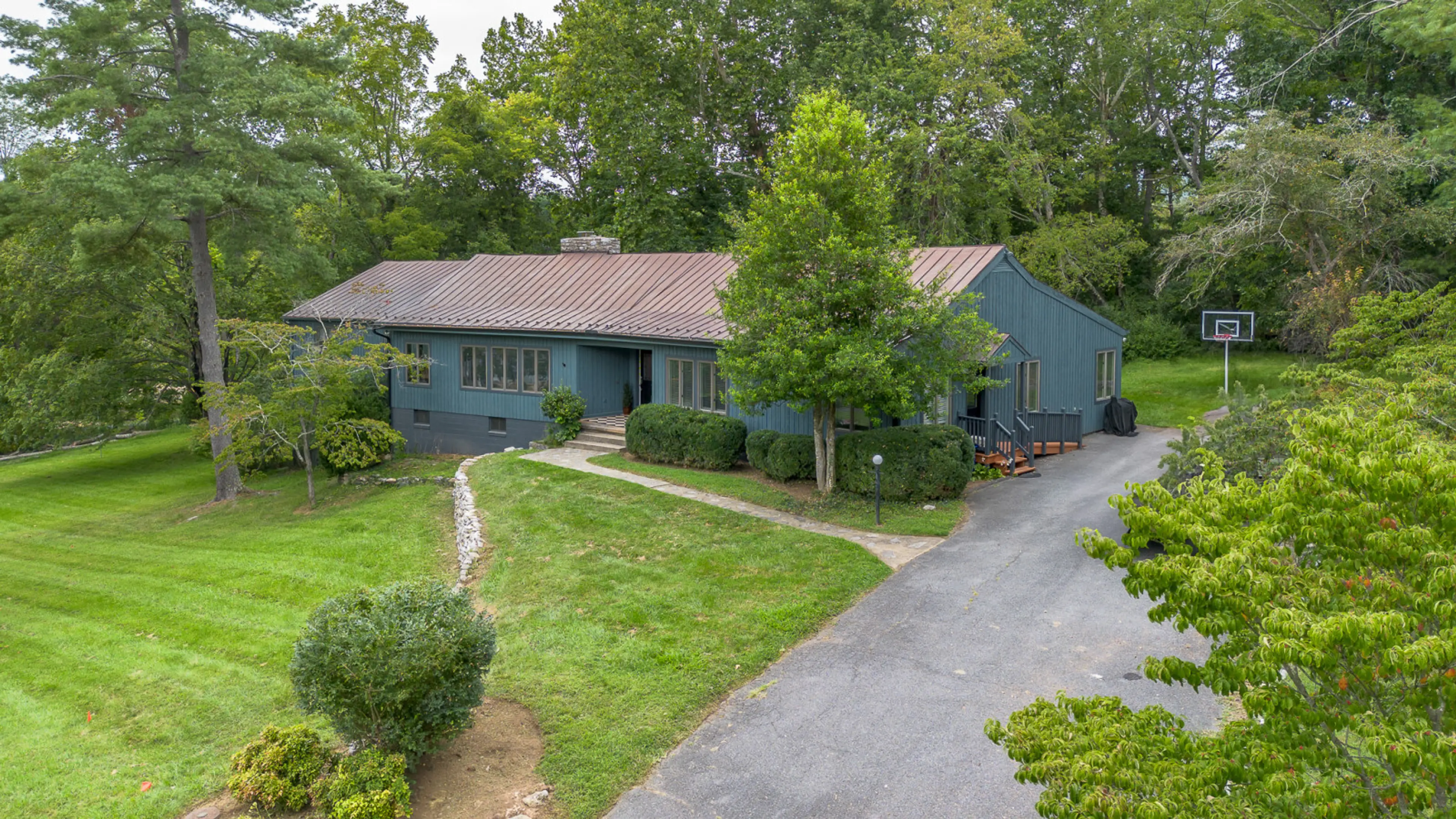 This mid century stunner with private driveway is located on a park like acre within city limits!