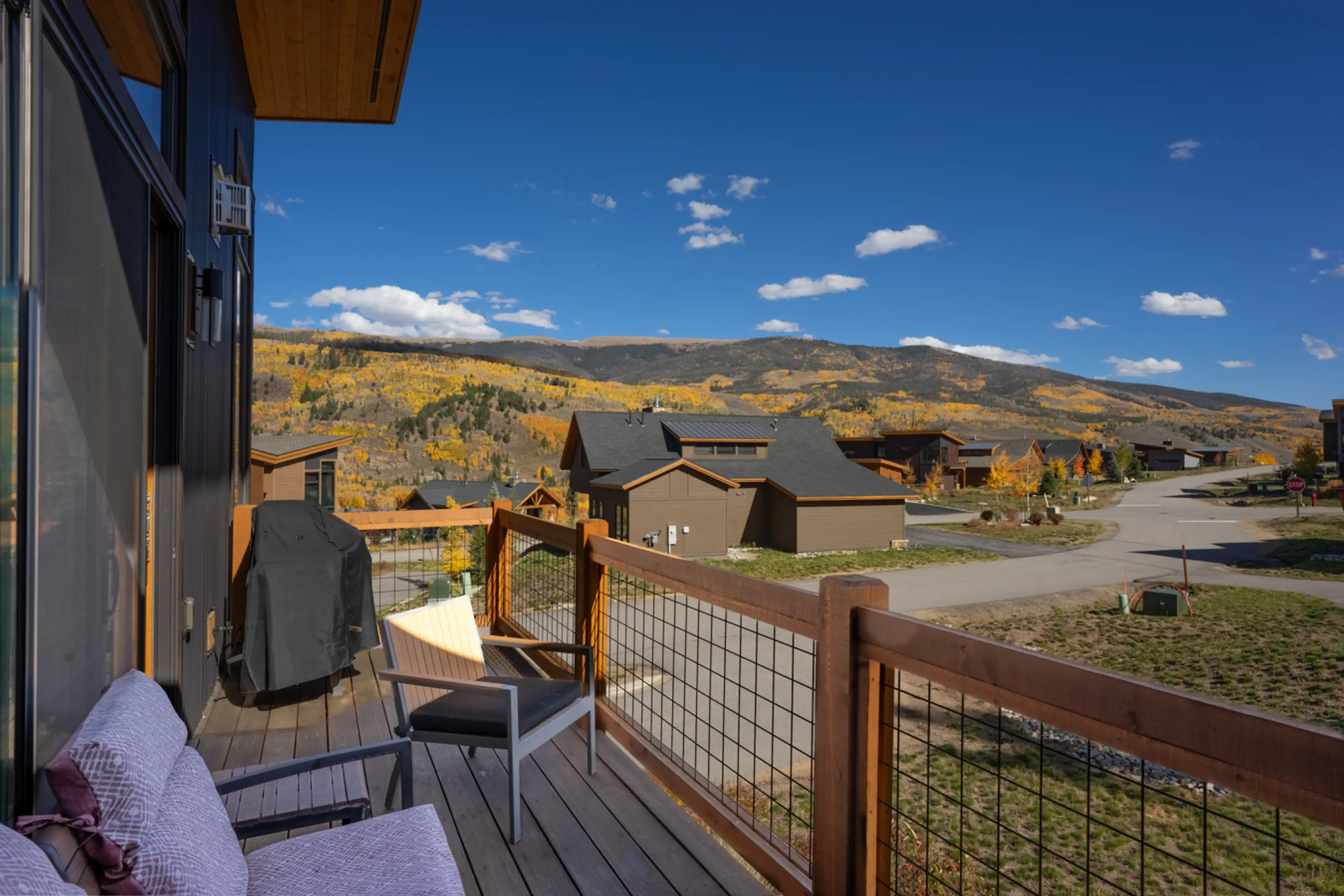 Private balcony featuring mountain views, gas grill and seating