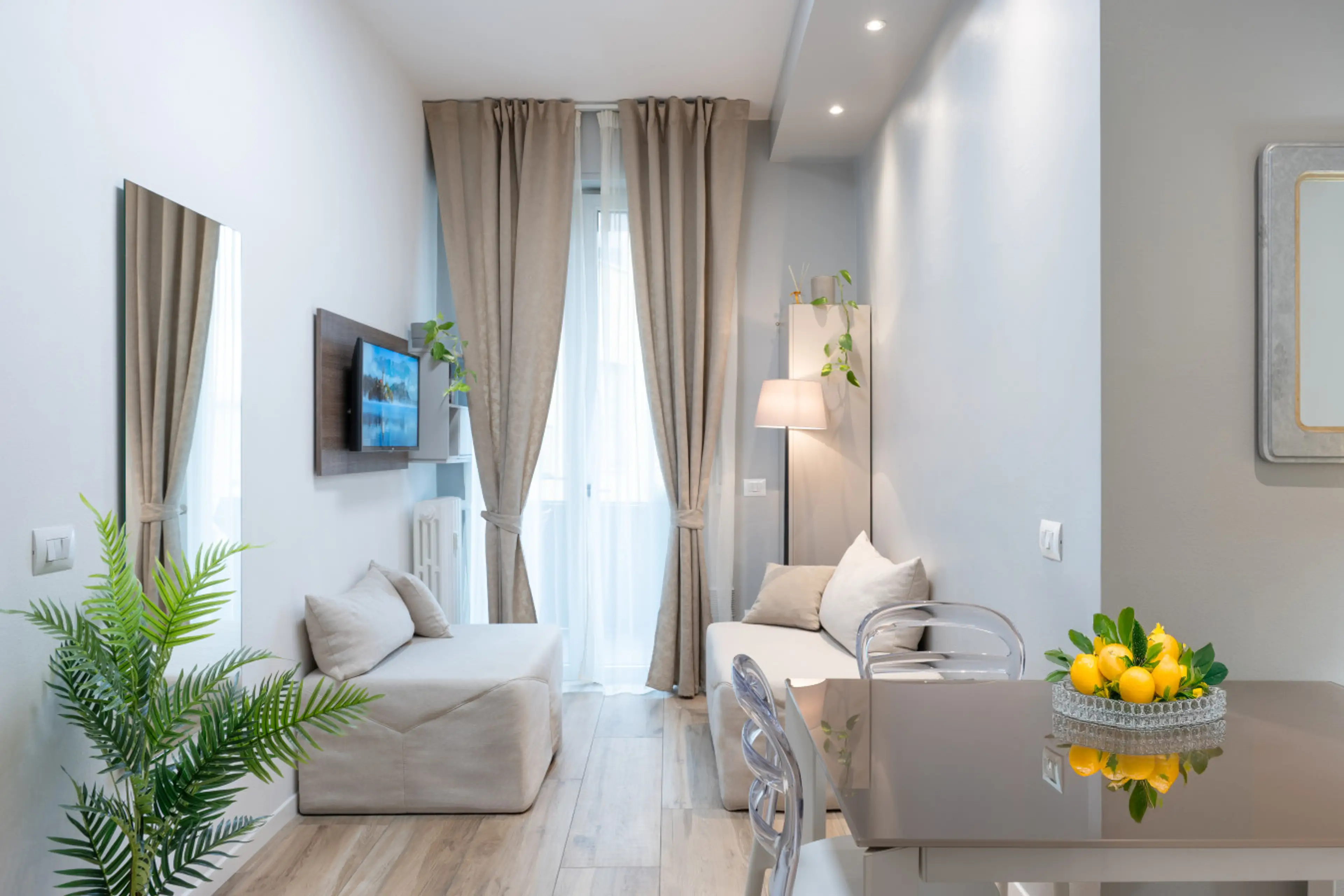 Living room with fully equipped kitchen, dining table, and sofa for a relaxing and practical stay